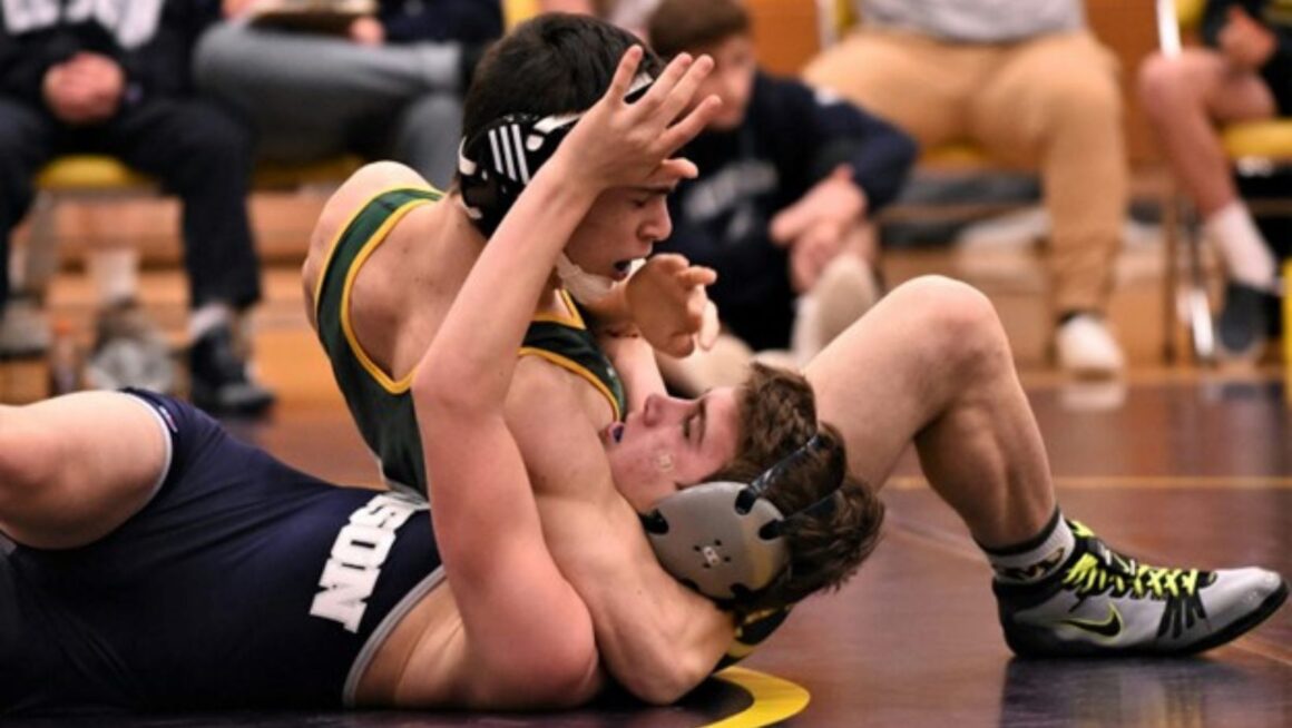 men fighting during a wrestling match